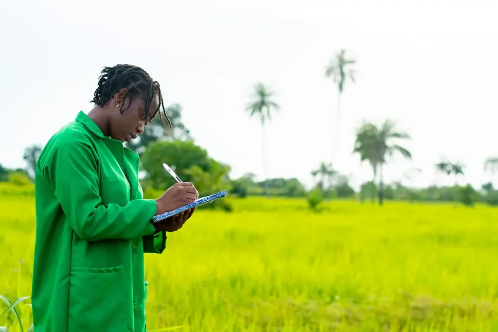 Smarter Farming- Greenlife Crop Protection Africa Agronomist recording crop research data in an African farm field — representing Greenlife Crop Protection Africa’s commitment to innovation, sustainability, and farmer support.
