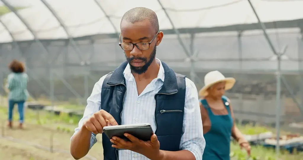 Growing Africa Together- Greenlife Crop Protection Africa Agronomist using digital tablet inside greenhouse — representing Greenlife Crop Protection Africa’s modern, science-based approach to sustainable farming and crop innovation.